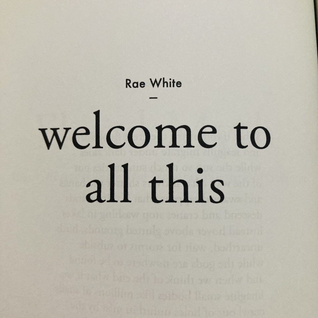 Photo of a white page with text that reads: ‘Rae White - welcome to all this.’