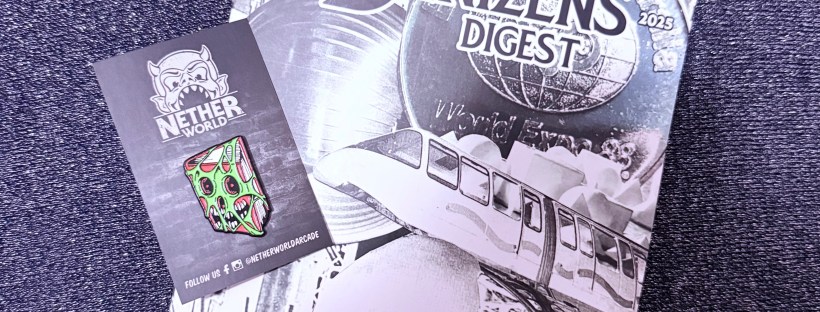 Photo of a copy of Denizen’s Digest, with a black and white Expo cover, and a creepy zine pin, on a glittery background.